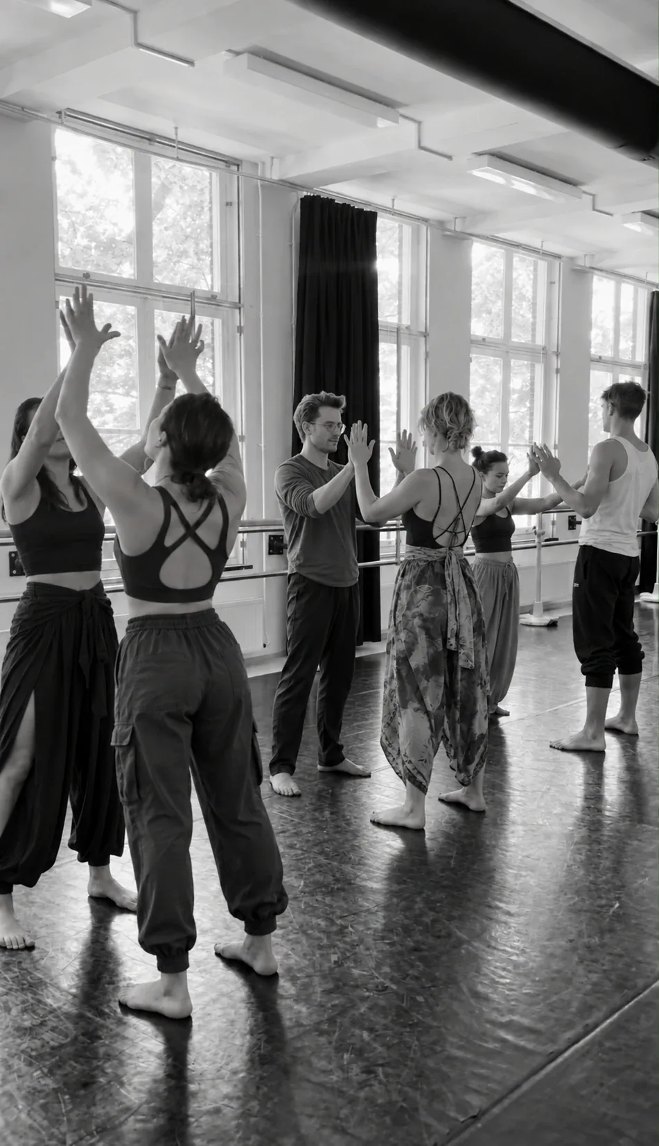 Participants standing with their arms raised in the studio