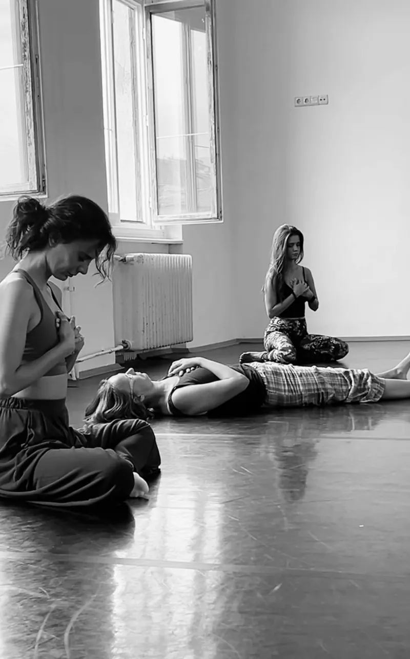 Participants sitting and lying on the floor, hands on their hearts