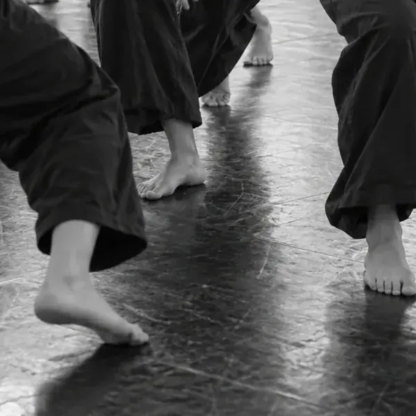 Bare feet of dancers on the studio floor
